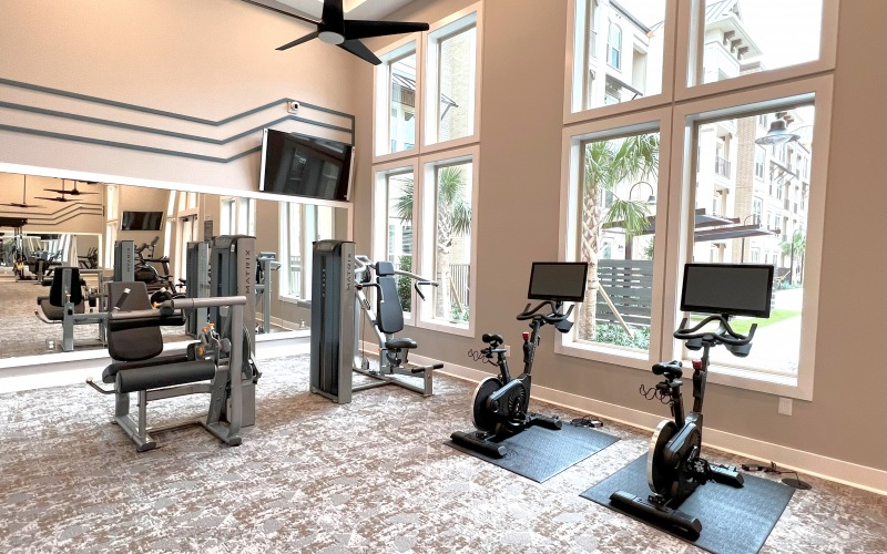a room with exercise equipment and windows